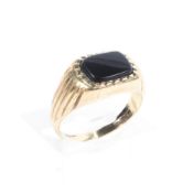 A 9ct gold signet ring, set with a rectangular onyx panel,