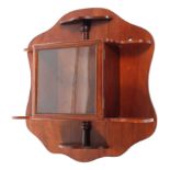 An Edwardian mahogany collectors glazed wall display cabinet mounted on a shaped wall plate with