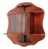 An Edwardian mahogany collectors glazed wall display cabinet mounted on a shaped wall plate with