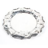 A Victorian trinket dish/card tray, of circular form, with embossed leaf decoration to its border,