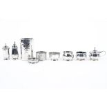 An assortment of silver wares, to include three napkin rings, two open salts, lidded mustard pot,