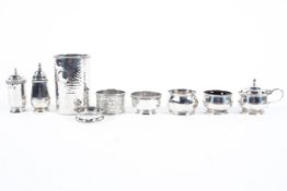 An assortment of silver wares, to include three napkin rings, two open salts, lidded mustard pot,