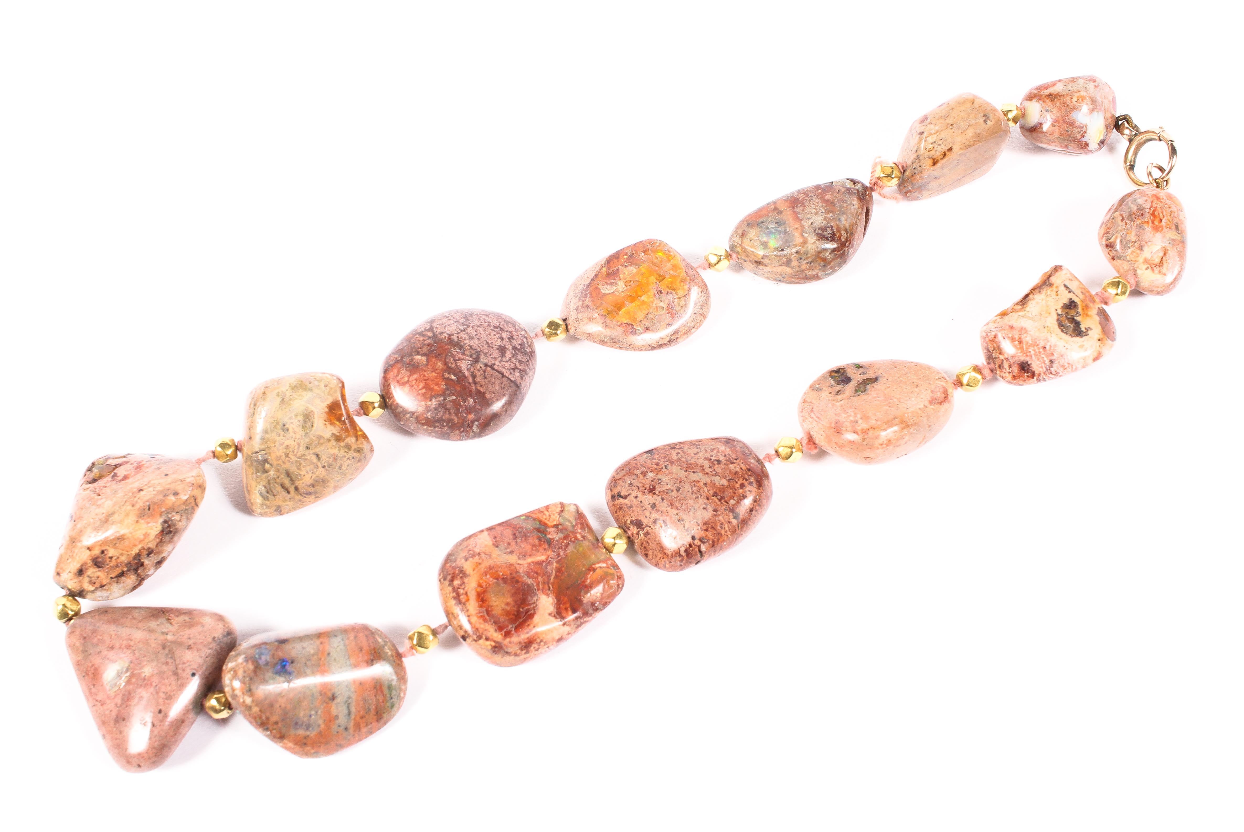 A set of free cut quartz beads set with sections of assorted opals,