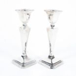 A pair of George V silver candlesticks, each raised on octagonal bases,