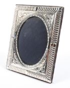 A contemporary silver picture of oval design, with foliate decoration,