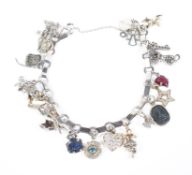 A Boucheron Paris (unmarked) white metal charm bracelet,