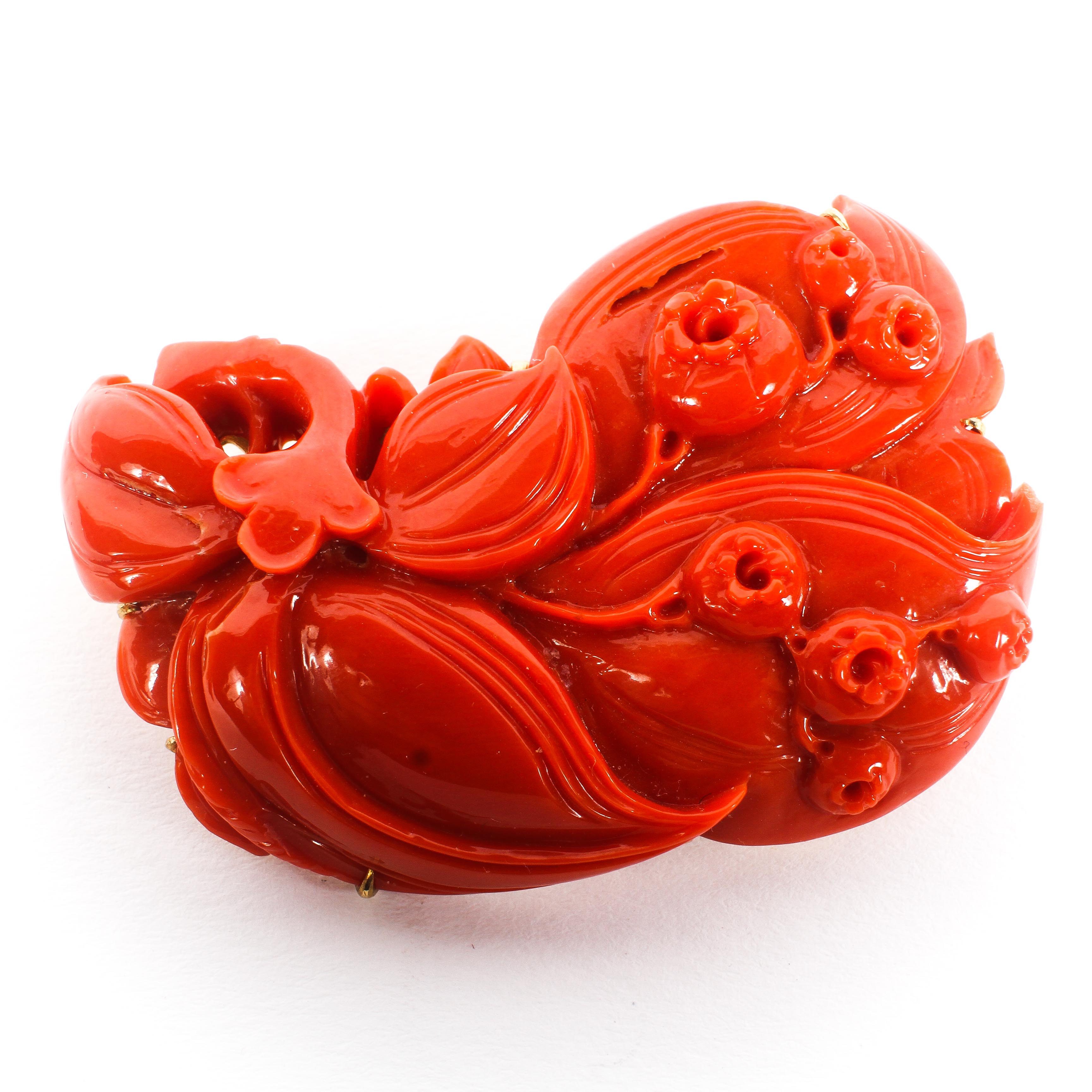 A 14ct gold mounted coral carved Art Nouveau style brooch, depicting flowers and berries,
