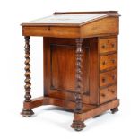 A 19th century leather topped davenport the rising lid to four bur maple drawers with barley twist