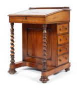 A 19th century leather topped davenport the rising lid to four bur maple drawers with barley twist