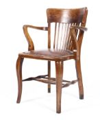 An arts and crafts oak elbow chair with square spindles,