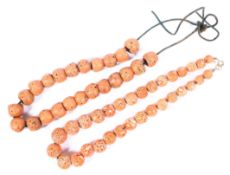 Two strands of Oriental carved pink coral beads.49cm 55cm .