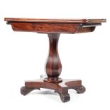 A Victorian mahogany fold over swivel topped tea table,