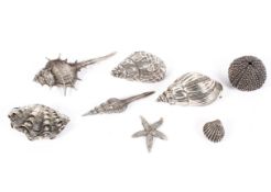 A collection of eight Continental silver and white metal models depicting shells,