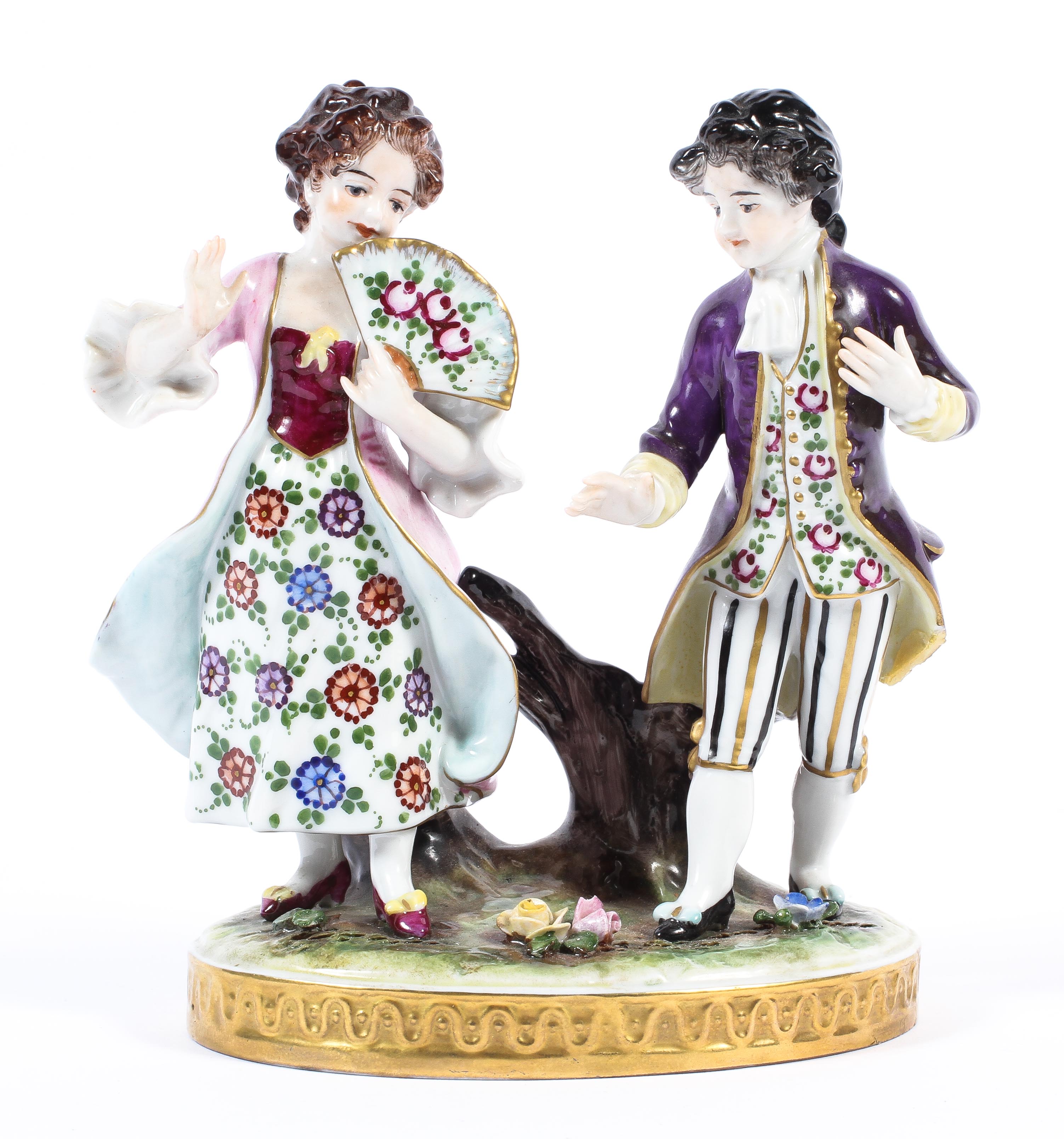 A continental porcelain figural group of a lady with fan in pink and a gentleman in purple jacket.