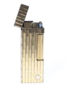 A gold plated Rollagas Dunhill engine turned lighter.