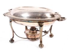 A lidded silver plated muffin dish or food warmer on plated stand with burner,