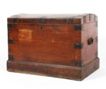 An early Victorian domed top iron-bound trunk on plinth base, with carry handles,