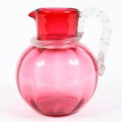 A Victorian cranberry glass jug,