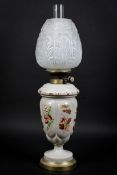 A Victorian ceramic painted decoration of foliage on oil lamp,