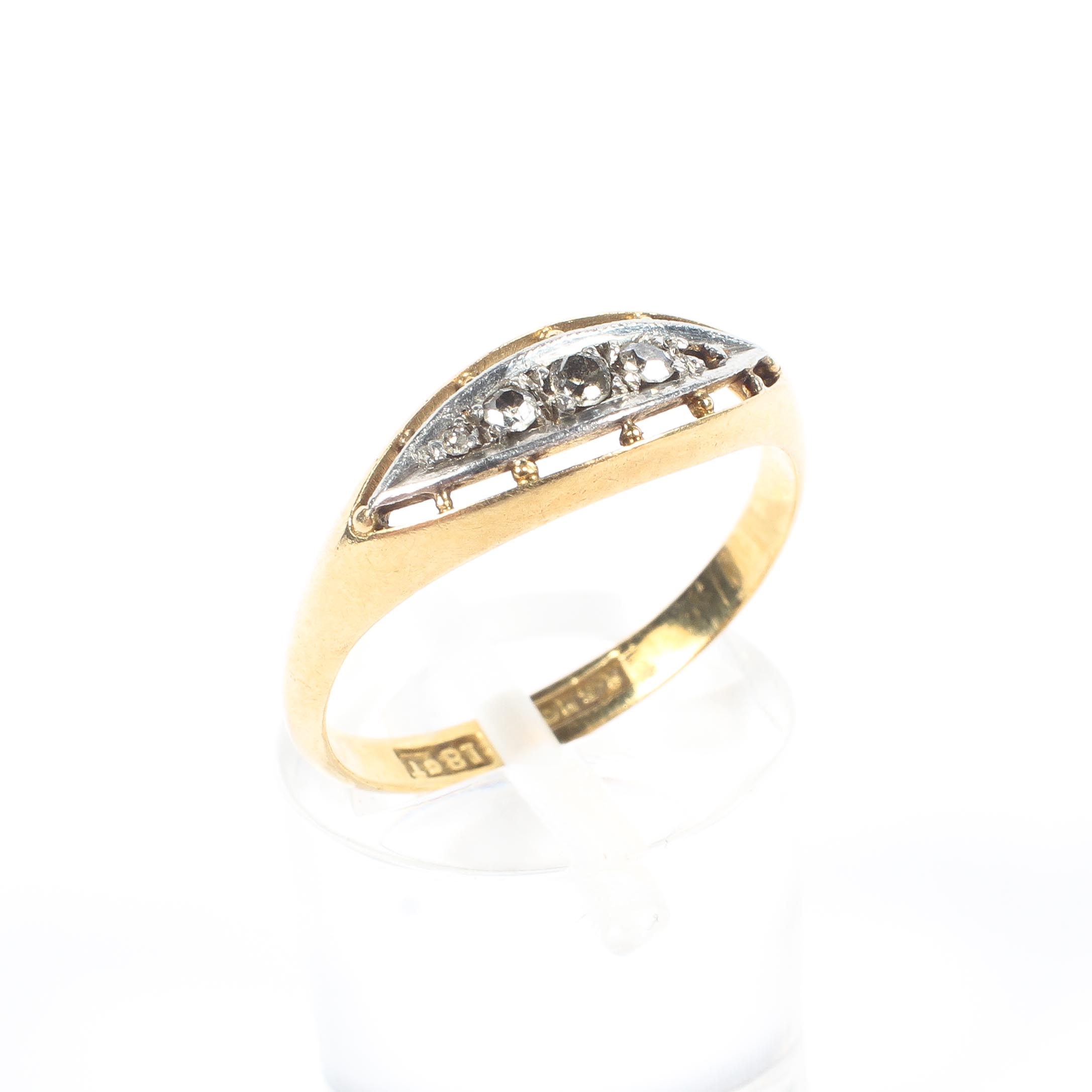 An 18ct gold and diamond ring, set with a graduated line of single cut diamonds (one stone missing),