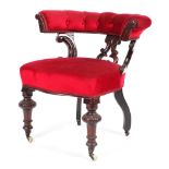 A mahogany button back upholstered armchair on carved supports with castors 77cm wide x 76cm