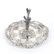 An Edwardian silver ring tree, the five branch tree mounted to highly embossed foliate base,