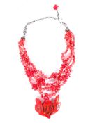 A double strand of red dogs tooth coral with large carved red coral flower pendant,