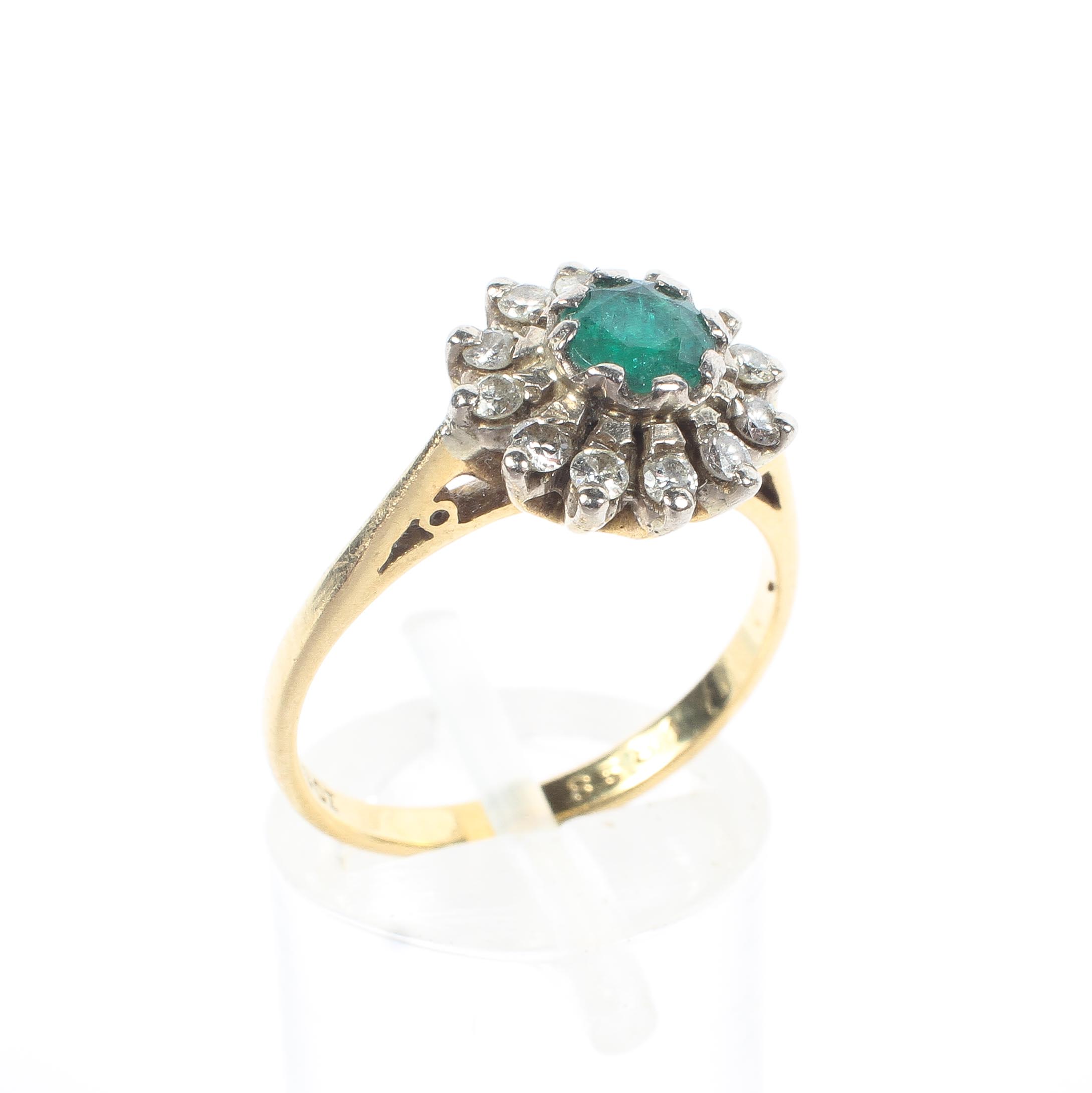 An 18ct gold emerald and diamond daisy ring,