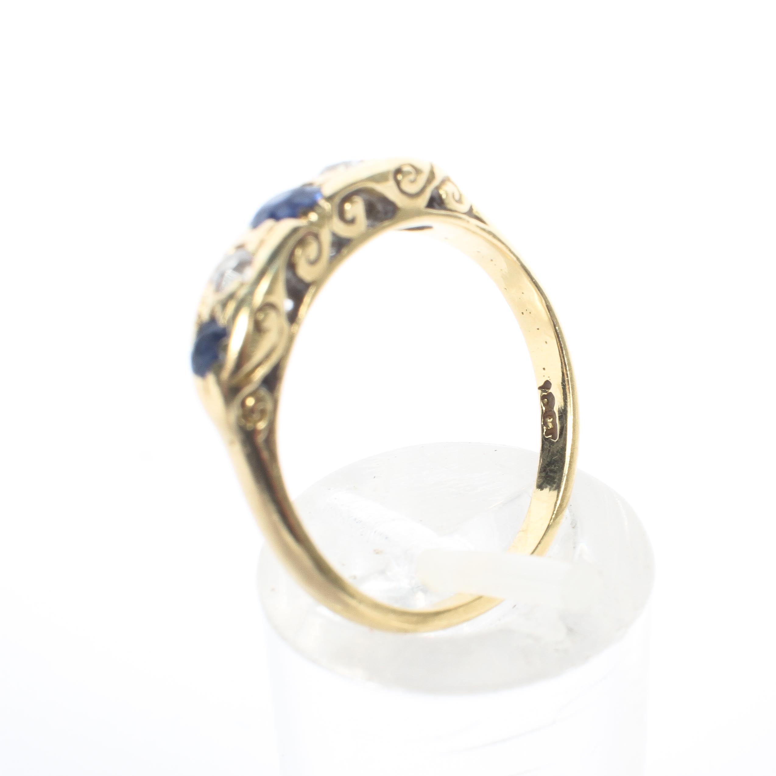 An 18ct yellow gold sapphire and diamond five stone ring, with pierced shank, stamped 18k, 3. - Image 4 of 4