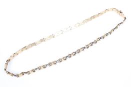 An Italian 9ct white and yellow gold flat fancy link necklace. 43cm. 18g.