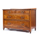 An Edwardian parllard oak chest of drawers on turned legs and original brass handle