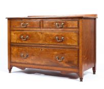 An Edwardian parllard oak chest of drawers on turned legs and original brass handle