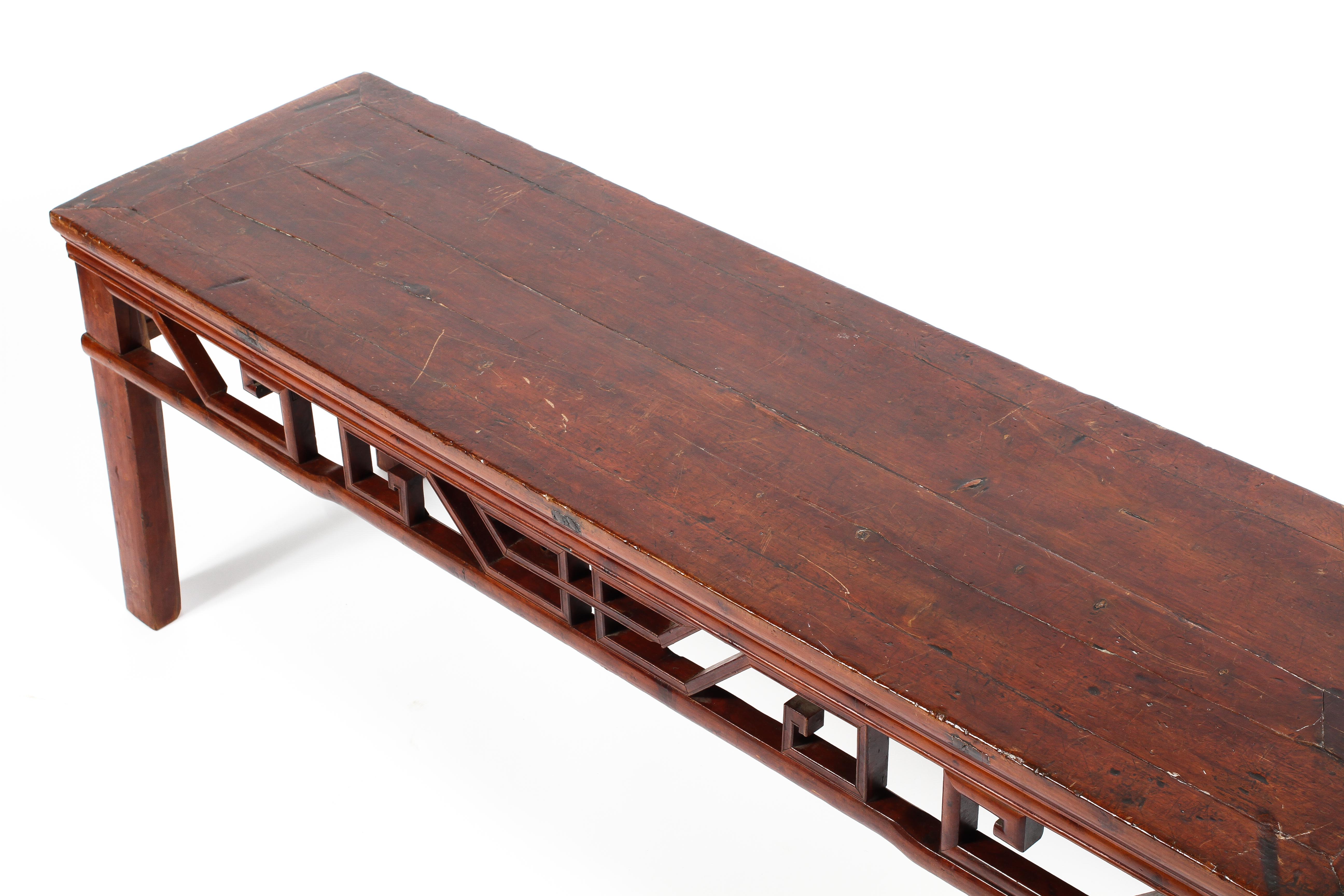 A late 19th century cherry wood elongated table with pierced geometric frieze raised on square - Image 2 of 2