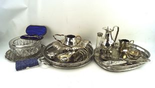 A collection of silver plate, including pierced trays, a glass salad bowl,