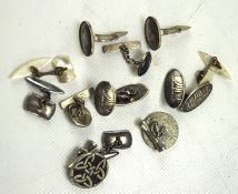 A collection of silver and white metal cufflinks,