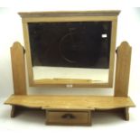 A pine dressing table top section with bevelled swing mirror above a small central drawer,