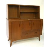 A mid 20th century G plan teak sideboard, the upper section with multiple shelves,