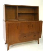 A mid 20th century G plan teak sideboard, the upper section with multiple shelves,