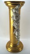 A cast resin pedestal, of columnal form, painted gold and decorated with fruit, height 66.