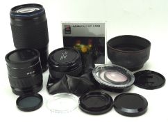 Collection of camera lenses, including a Tokina 75-300mm AF lens,