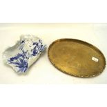 A Japanese blue and white dish and Chinese brass tray, the dish in the form of a Lotus leaf,