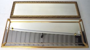 Two contemporary bevelled edge wall mirrors, both of rectangular form with moulded gilt frames,
