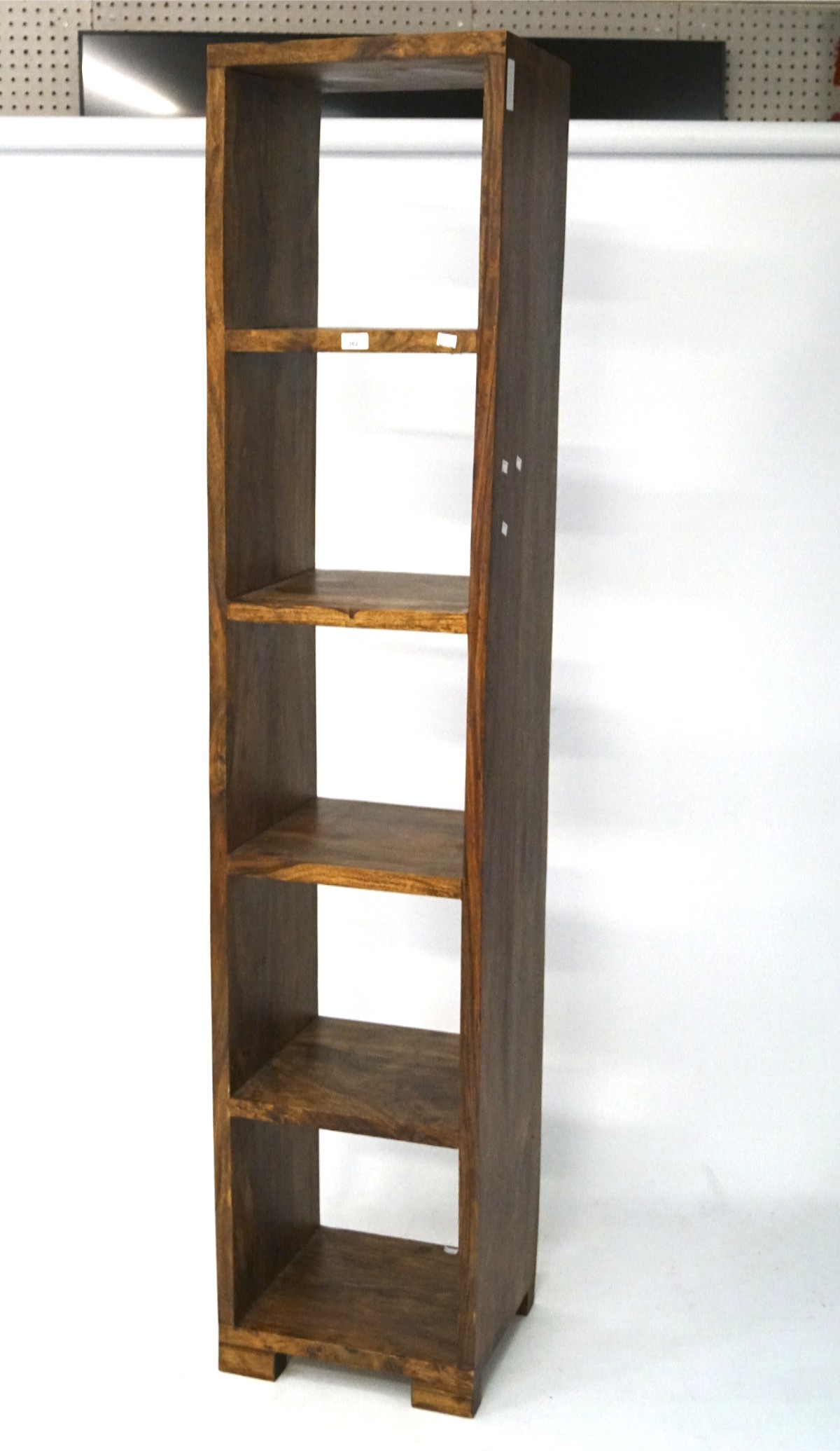 A large hardwood display unit, comprising of five compartments, on raised supports,