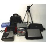 A collection of laptops, camera lenses and electronic devices, including an Acer laptop, a tripod,