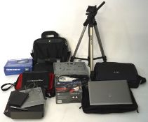 A collection of laptops, camera lenses and electronic devices, including an Acer laptop, a tripod,