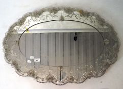 A contemporary wall mirror, of oval form,