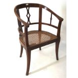 A late 19th-early 20th century chair, the wooden frame with wicker seat,