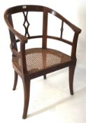 A late 19th-early 20th century chair, the wooden frame with wicker seat,