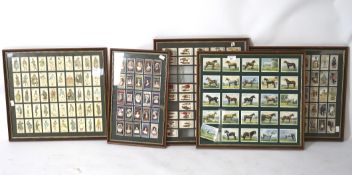 Five framed sets of cigarette cards, featuring sports figures, royalty, horses and more,