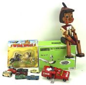 A collection of toys, including a wooden model of pinocchio,